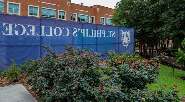 Campus photo with SPC Tiger and St. Philip's College fence wrap